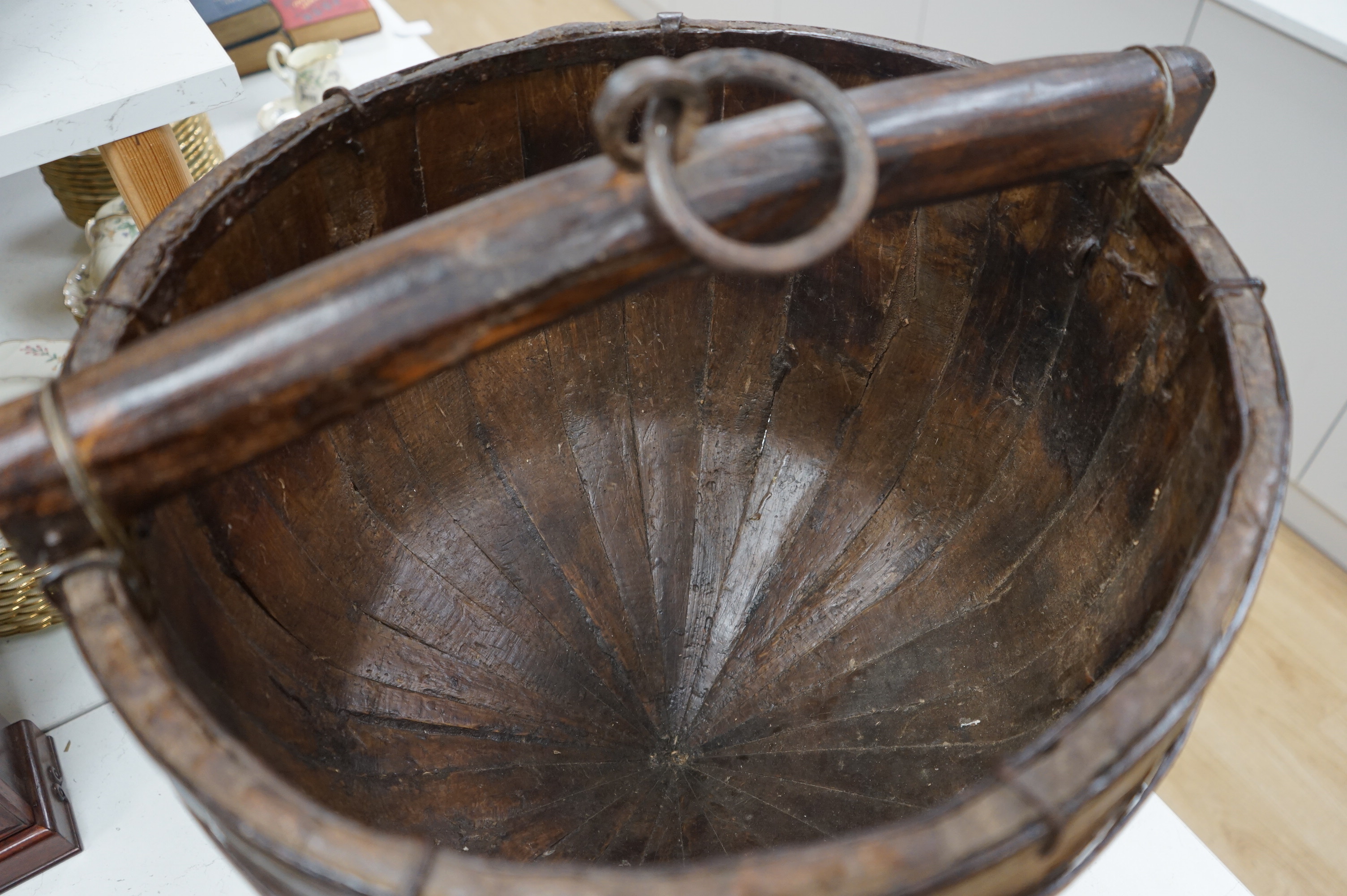 A Chinese wooden and metal bound pail on stand, approximately 55 cm high. Condition - good